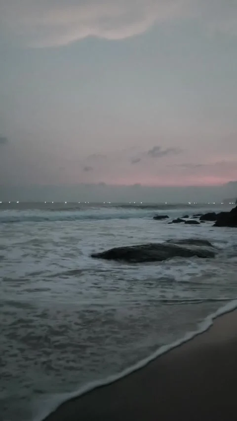 Sunset Beach with Waves and Boat Lights in the Distant Stock Footage 333496911