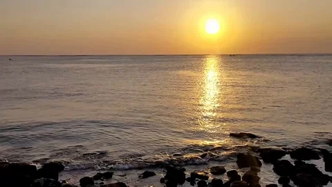 Sunset on the beach with waves breaking gently on a sandy Stock Footage 115966781