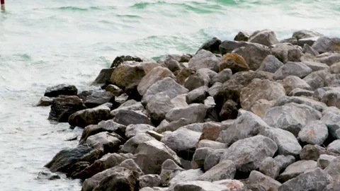 Sunset at the beach with waves crashing on cliffs. Stock Footage 117409548