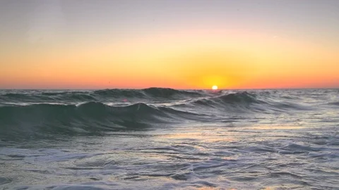 Sunset beach as waves roll in slow motion Stock Footage 112030810