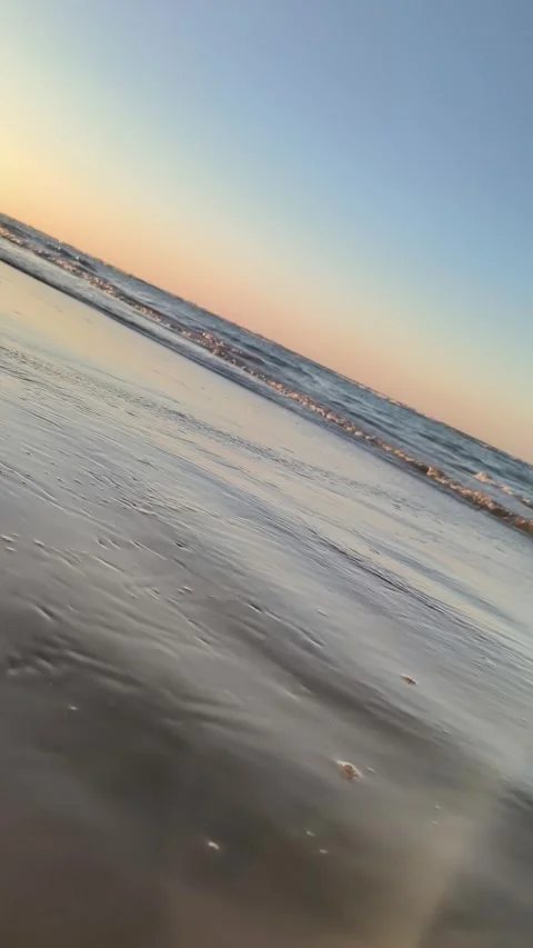 Sunset Beach Waves Vertical 4K - Serene Ocean Shoreline at Golden Hour Stock Footage 340381679