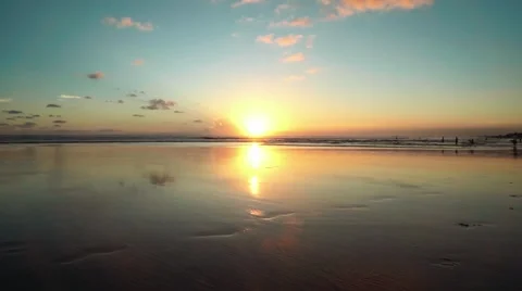 Sunset beach with wet sand reflecting the sky, Bali, Seminyak Stock Footage 65409635
