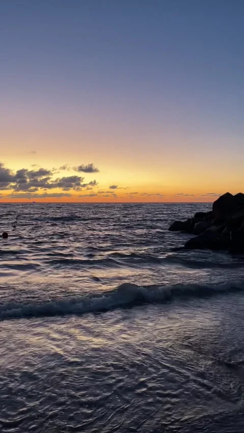 Sunset on the beach yellow and blue colors, tranquility and peace Stock Footage 248579371