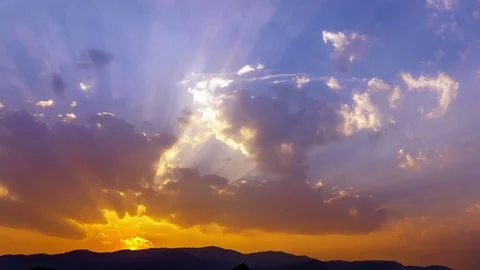 Sunset beams filtering through clouds Stock Footage