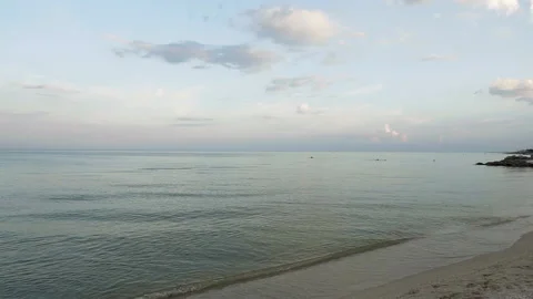 Sunset on beautiful sand beach with stone rocks in the sea water, slow motion Stock Footage 92742152