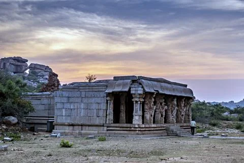Sunset behind ancient stone temple in Vitthala temple complex in Hampi. Stock Photos