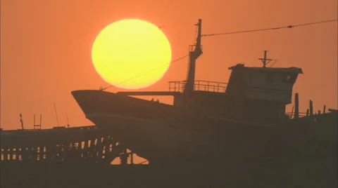 Sunset behind a boat Stock Footage 38616017