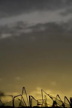 Sunset behind the broken glass. Stock Photos