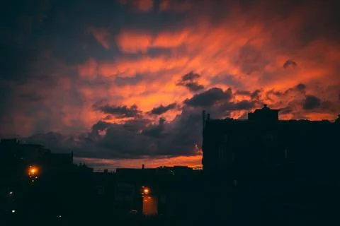 Sunset behind buildings Stock Photos