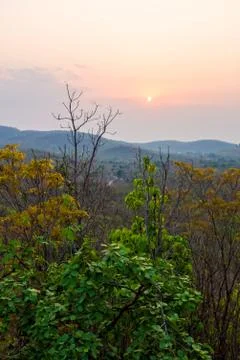 Sunset behind cloud at horizon of sky and mountain Stock Photos