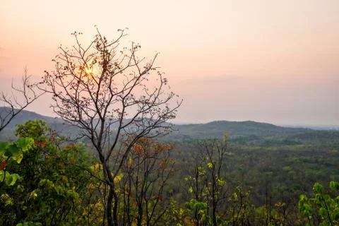 Sunset behind cloud at horizon of sky and mountain Stock Photos