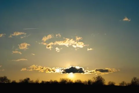 Sunset behind a cloud Stock Photos