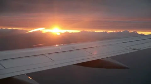 Sunset behind clouds from Airplane Video stock 11350273