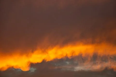 Sunset behind clouds and orange sky with clouds in Ukraine Stock Photos