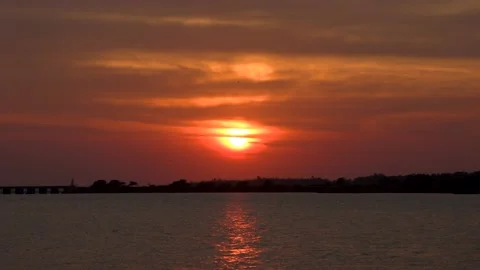 Sunset behind clouds a beautiful evening with red sky Stock Footage 172495389