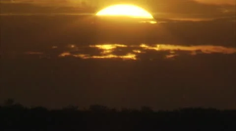 Sunset behind clouds Stock-Footage 12761582