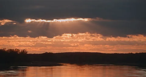 Sunset behind clouds light rays Stock Footage 242786829