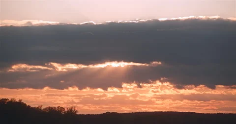 Sunset behind clouds light rays Stock Footage 242787609