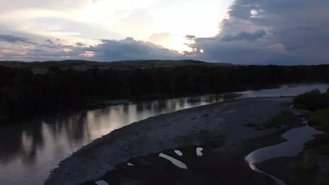Sunset behind clouds over river Stock Footage 312035202