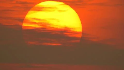 Sunset behind clouds Stock Photos