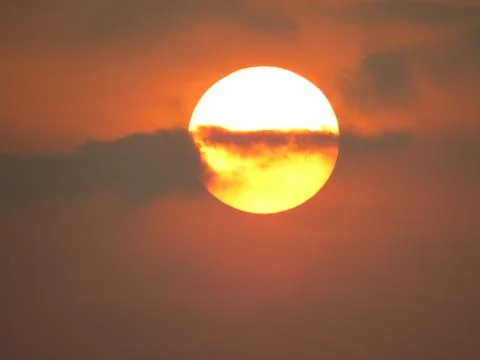 Sunset behind clouds Stock Photos