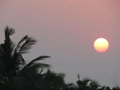 Sunset behind clouds Stock Photos
