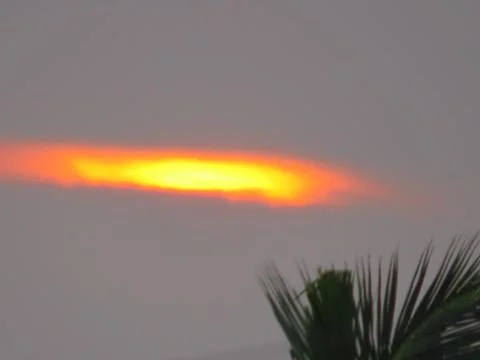 Sunset behind clouds Stock Photos