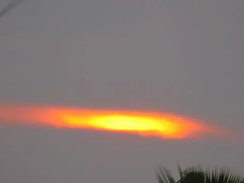 Sunset behind clouds Stock Photos