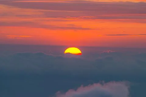 Sunset behind the clouds Stock Photos