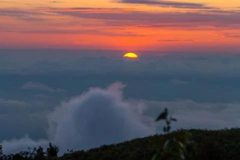 Sunset behind the clouds Stock Photos