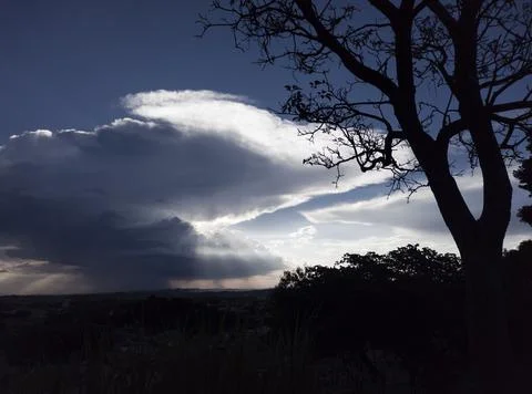 Sunset behind the clouds. Stock Photos