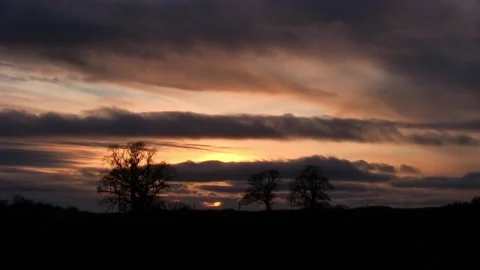 Sunset behind clouds timelapse Stock Footage 153216917