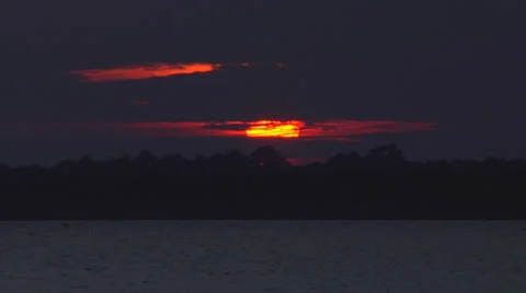 Sunset behind clouds on the waterway, zoomed, 300% Stock Footage 24453720