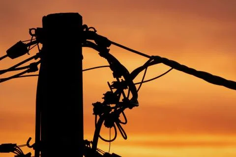Sunset behind the electricity pillar. Stock Photos
