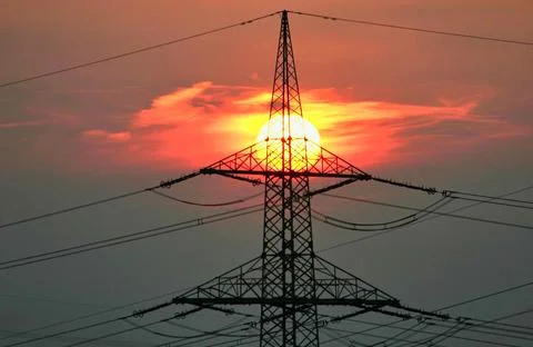 Sunset behind a high voltage pylon solar energy climate neutral change climatic Stock Photos