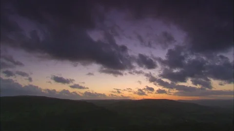 Sunset behind hills with clouds sky Video stock 95604542