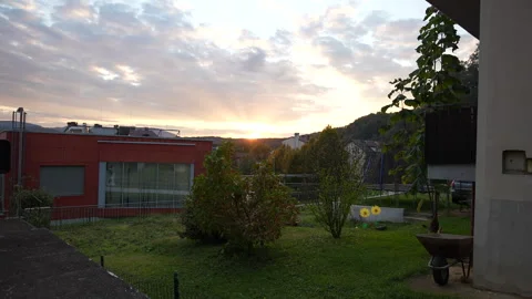Sunset behind the hills over small town Stock Footage 320603875