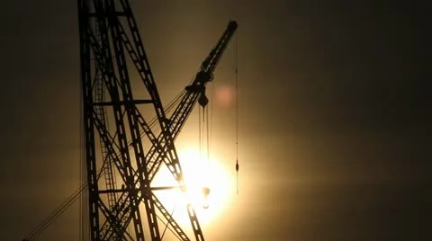 Sunset behind industrial cranes Vídeo Stock 10795691