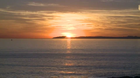 Sunset behind island in the ocean Stock Footage 925717