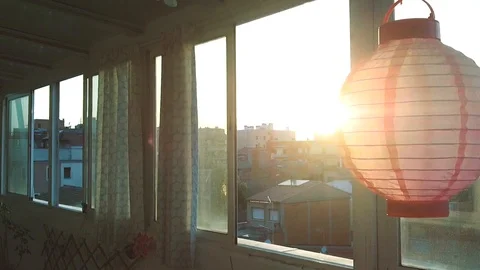 Sunset behind a lantern at the balcony  Stock Footage 103573349