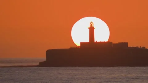 Sunset behind lighthouse silhouette with perfect sun alignment Fuerteventura 스톡 동영상 331163069