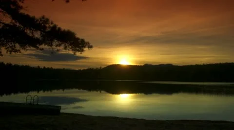 Sunset Behind Mountain and Over Lake Stock Footage 12320580