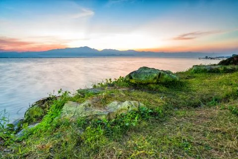 Sunset behind mountain in lagoon Foto stock
