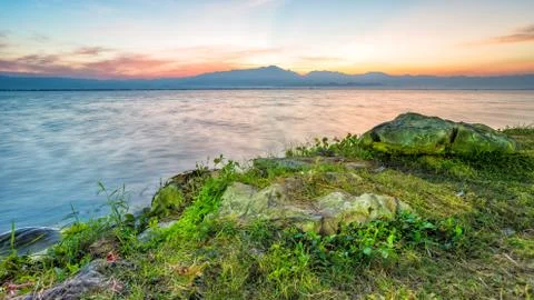 Sunset behind mountain in lagoon Stock Photos