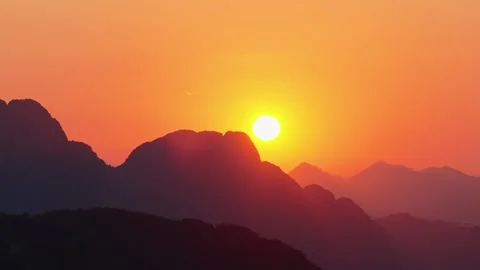 Sunset Behind Mountain Silhouettes over Scenic Tropical Landscape Stock-Footage 330814387