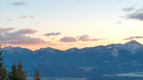 Sunset behind the mountains and forest, gray and orange clouds Stock Footage 256648115