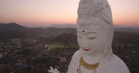 Sunset Behind Mountains and Goddess of Mercy Statue, Chiang Rai, Thailand, Video stock 78696997