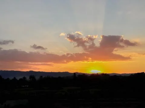 Sunset behind the mountains Stock Photos