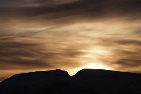 Sunset behind Mountains Stock Photos