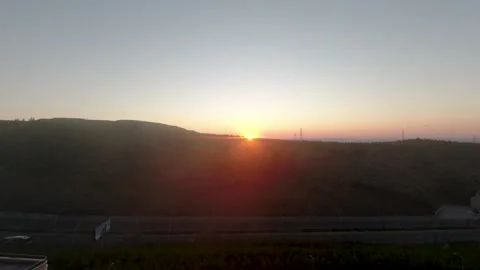 Sunset from behind the mountains timelapse Stock Footage 144976527